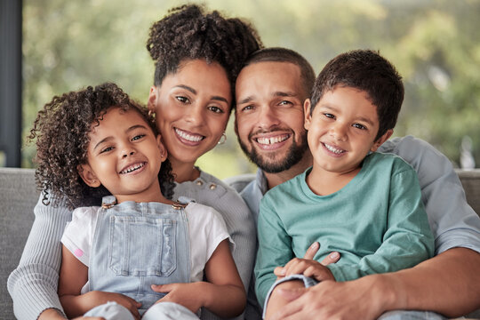A family smiling together on a couch